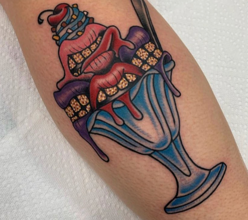 A tattoo of an ice cream sundae with a cherry on top