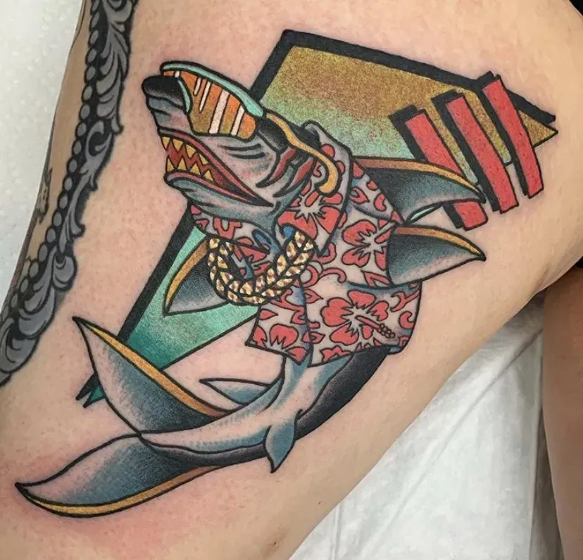 A tattoo of a shark wearing a hawaiian shirt