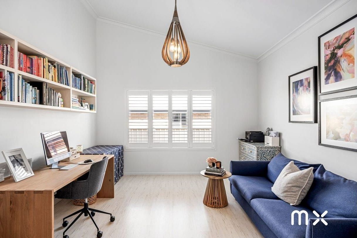 A Woman Wearing Yellow Gloves Is Holding a Sponge — Complete Clean Home Cleaning in Primbee, NSW