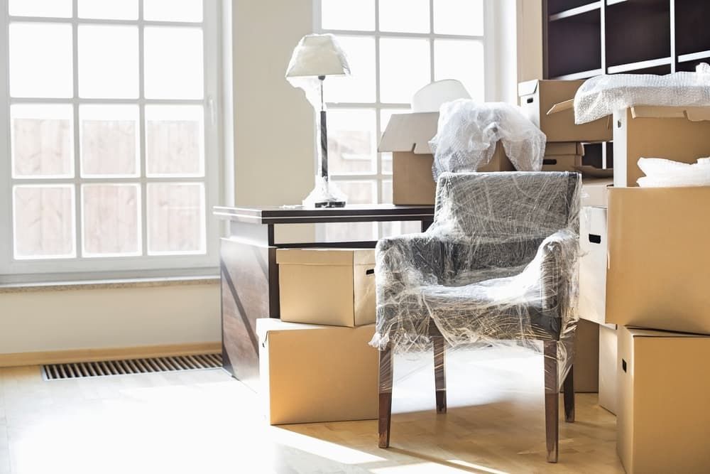 A Chair Wrapped in Plastic Is Sitting in A Room — Complete Clean Home Cleaning in Dapto, NSW