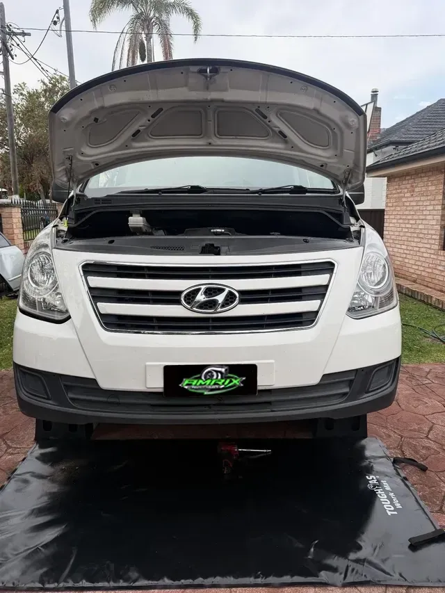 White Hyundai van with open hood, on a mat, outdoors — Amrix Automotive In Bankstown, NSW