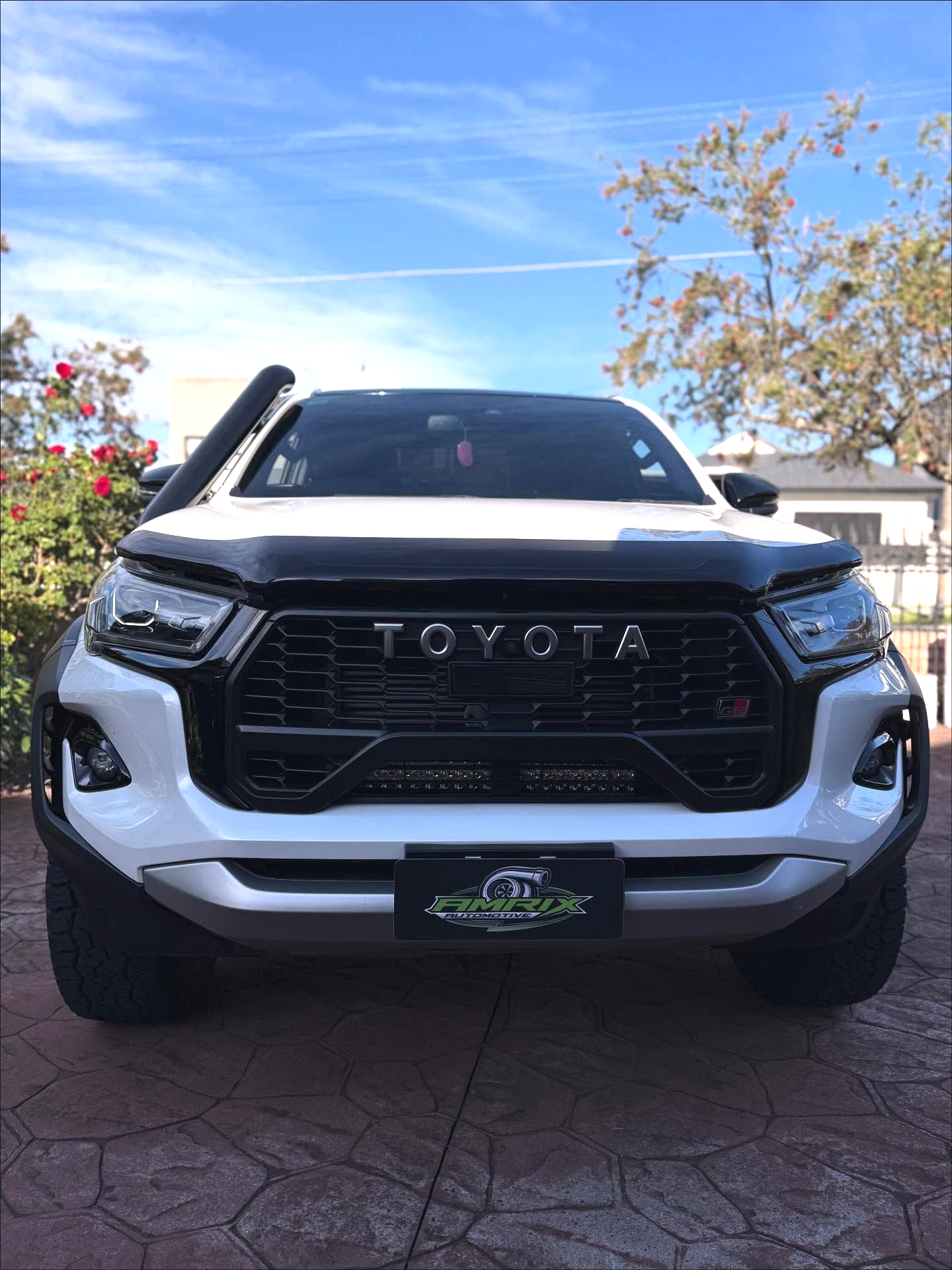 White Hyundai van with open hood parked on a black mat, outdoors — Amrix Automotive In Sefton, NSW