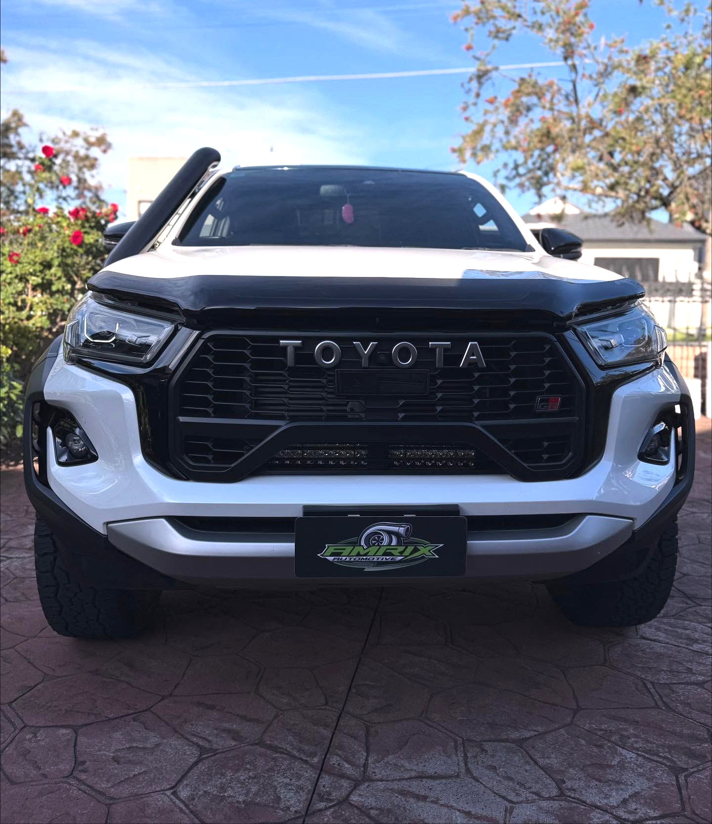 White Toyota truck with black trim, a snorkel, and a custom grill, parked outdoors — Amrix Automotive In Bankstown, NSW