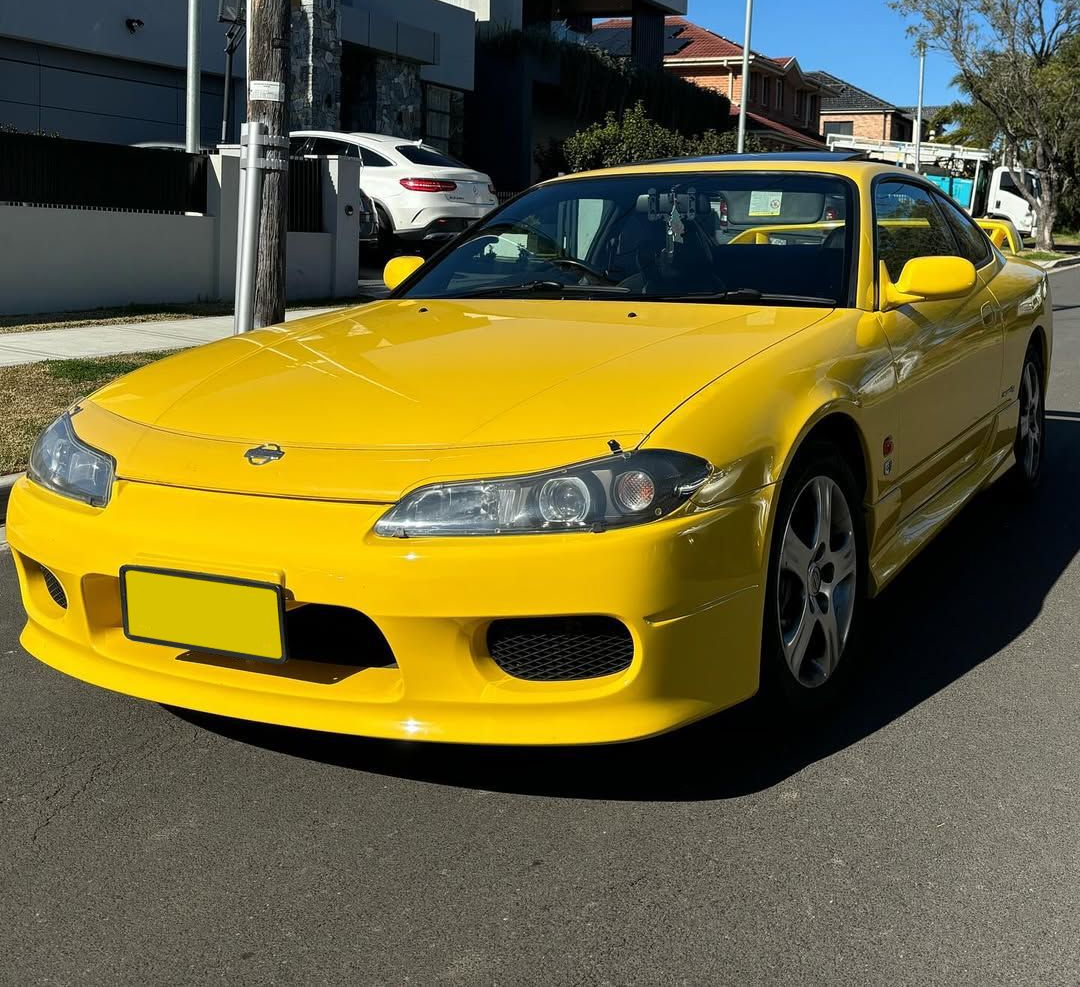 Yellow sports car parked on a street in front of houses on a sunny day — Amrix Automotive In Bankstown, NSW