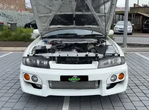 White Nissan Skyline R33 With Hood Open, Parked on Cobblestone — Amrix Automotive In Strathfield, NSW