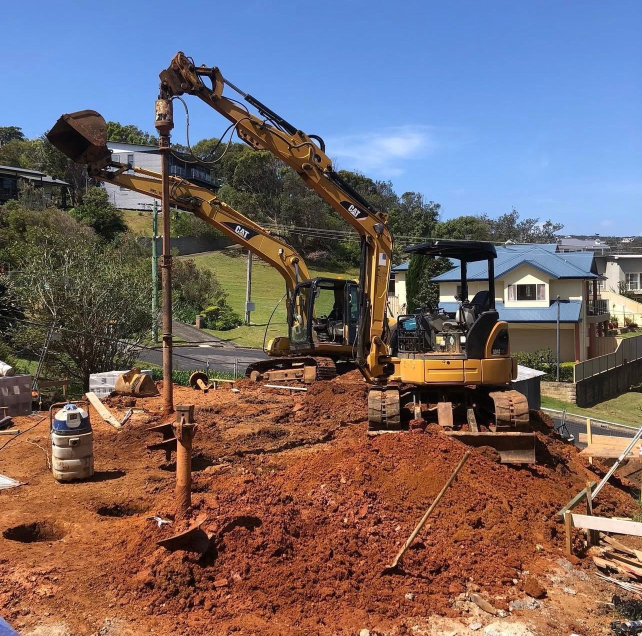 Excavator in construction site, yellow and black machine digging earth.