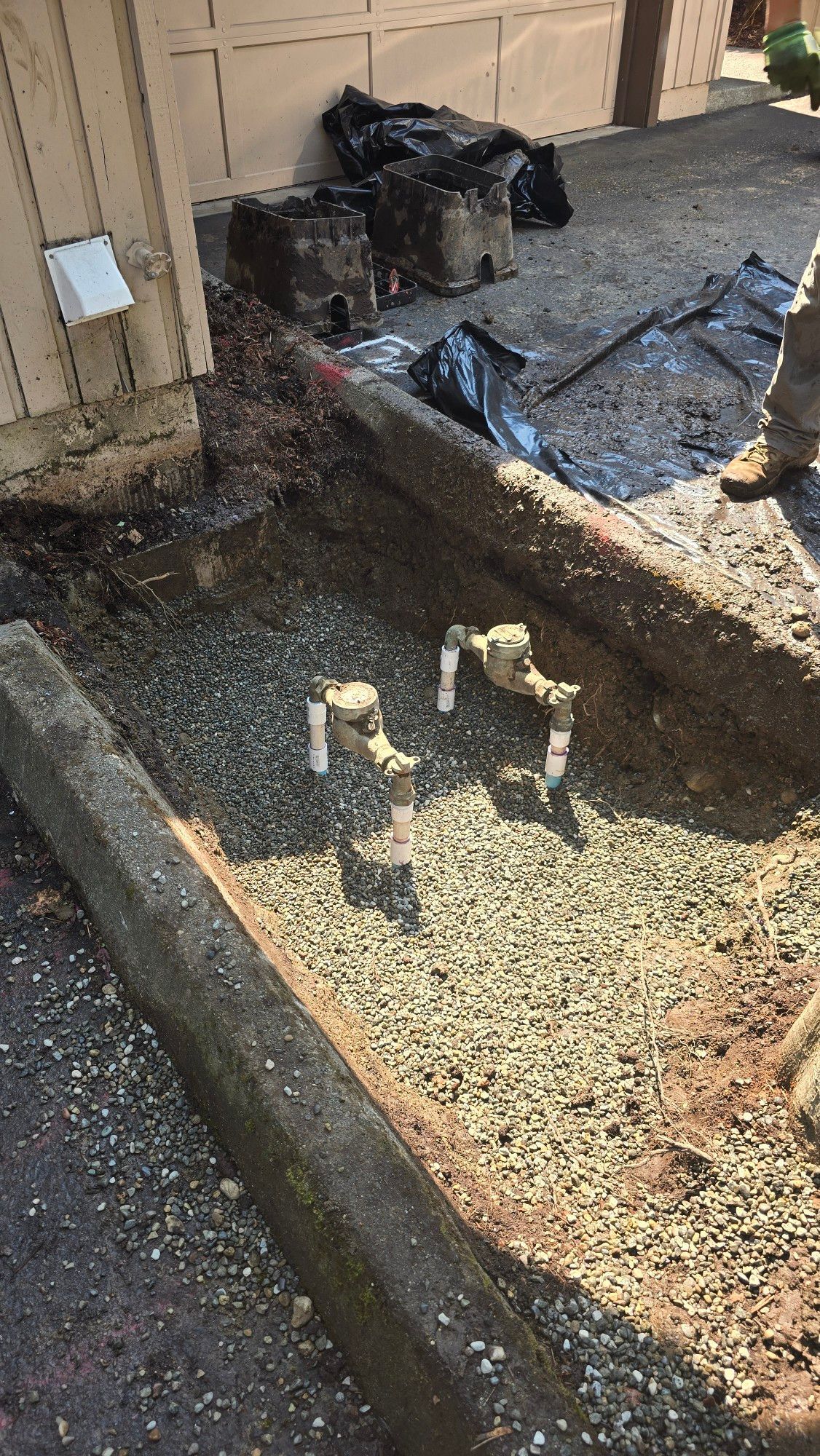 Two water valves in a trench filled wit