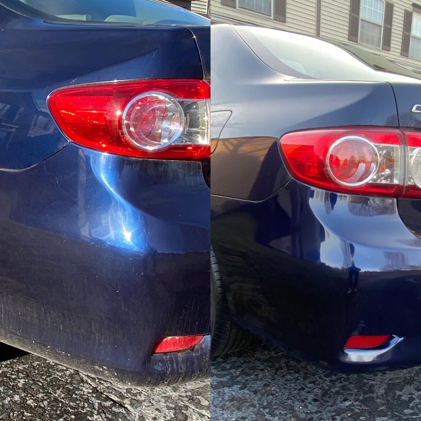 Rear view of two dark blue cars with one bumper pressed against the other in a parking area.