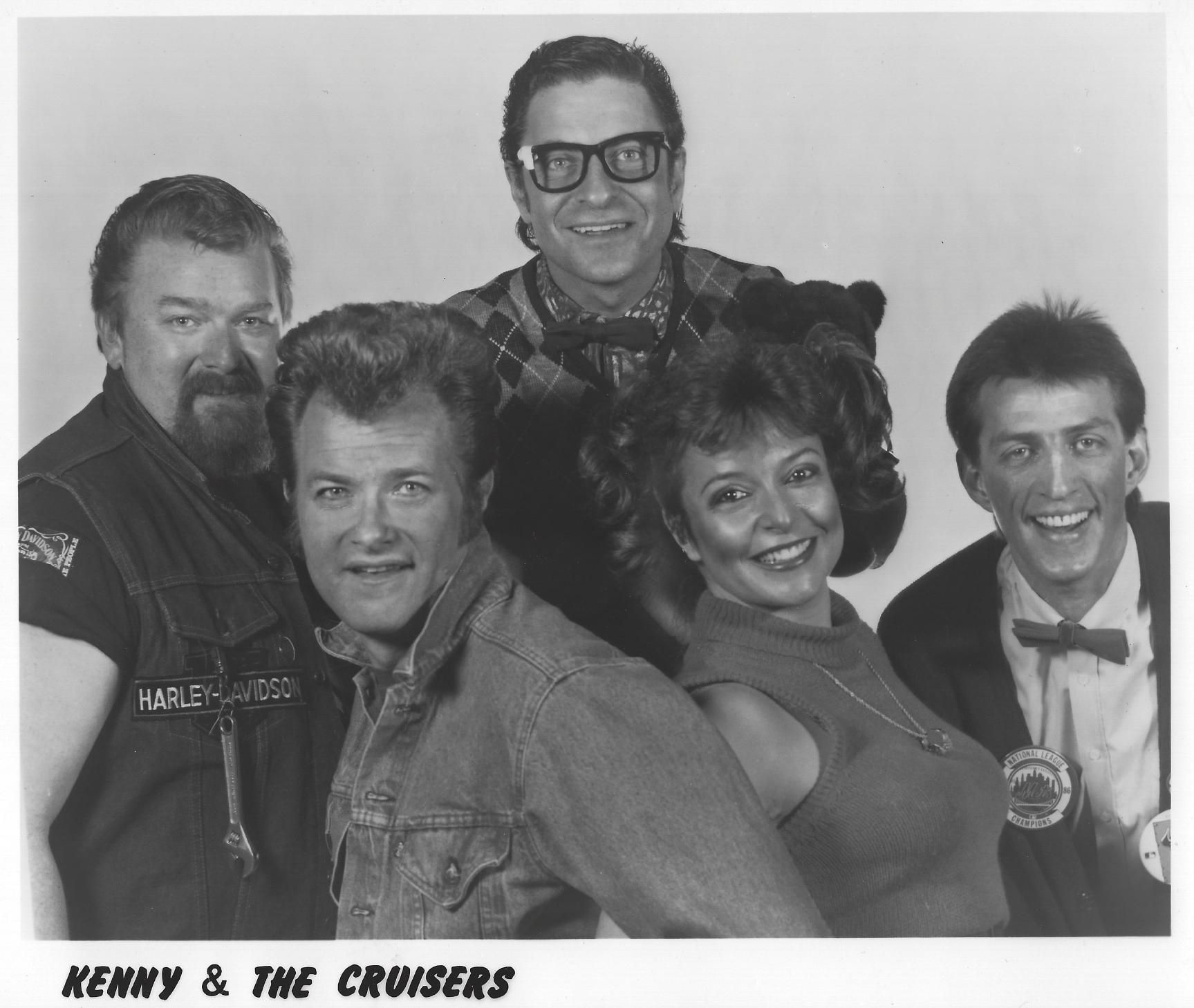 Black-and-white group portrait of five smiling performers labeled “Kenny & The Cruisers”