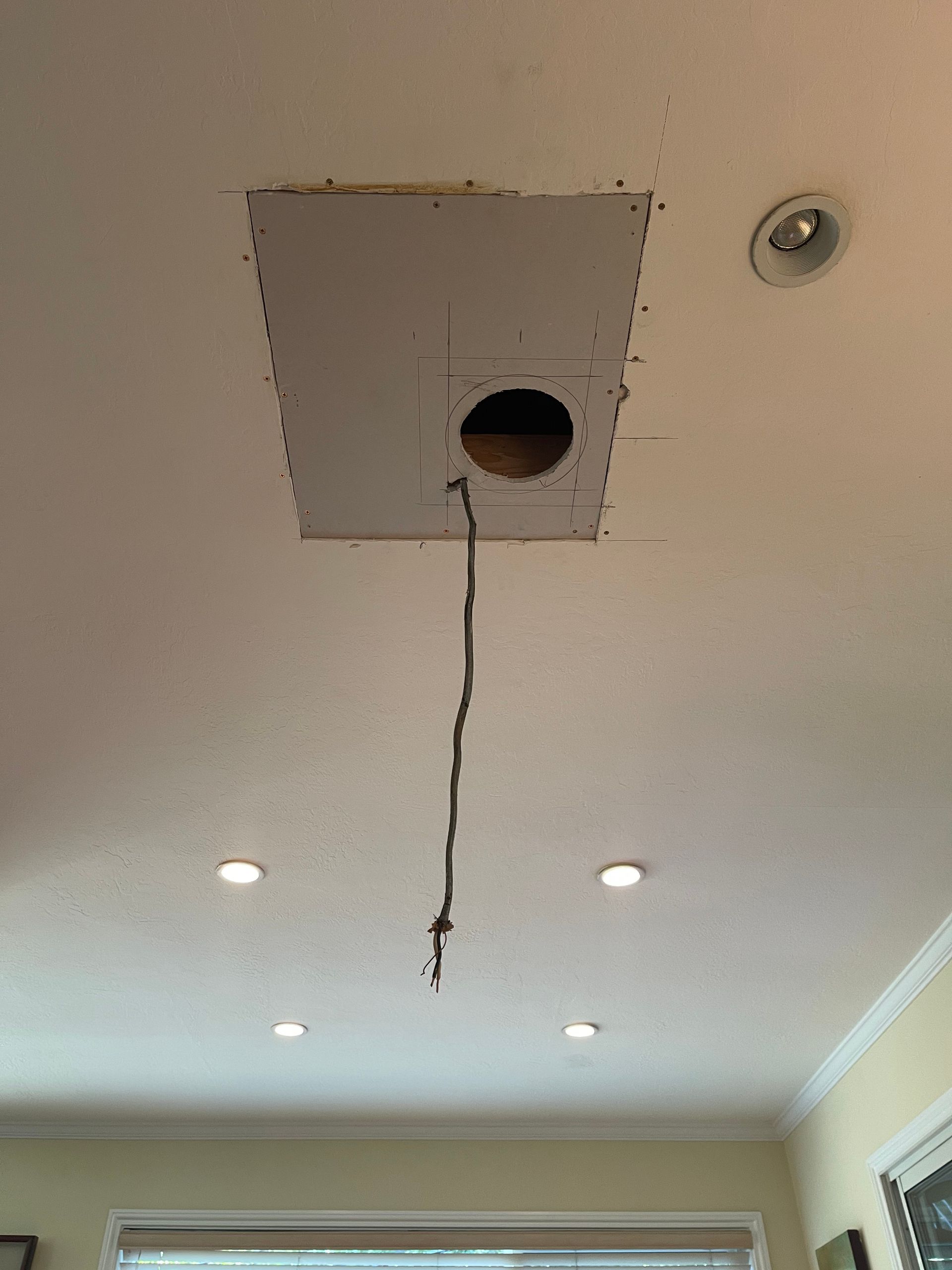 Ceiling with a rectangular hole and exposed wiring; several recessed lights are also visible.