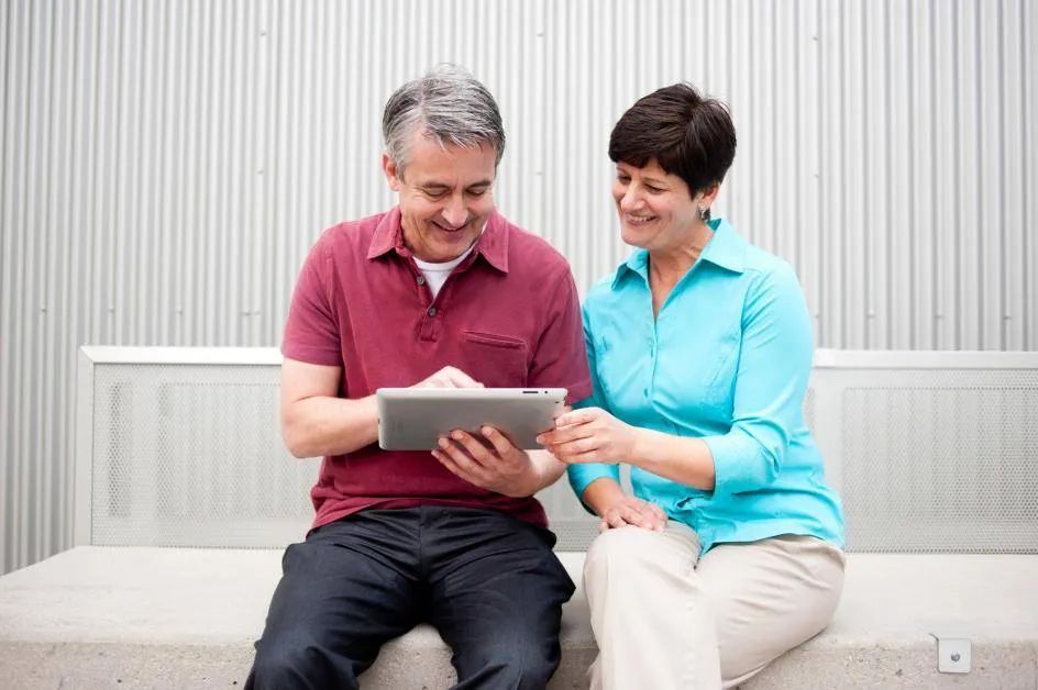 couple looking in tab