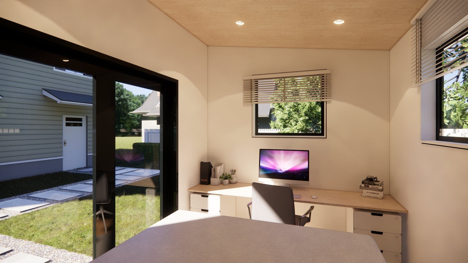 A bedroom with a bed and a desk with a computer on it.
