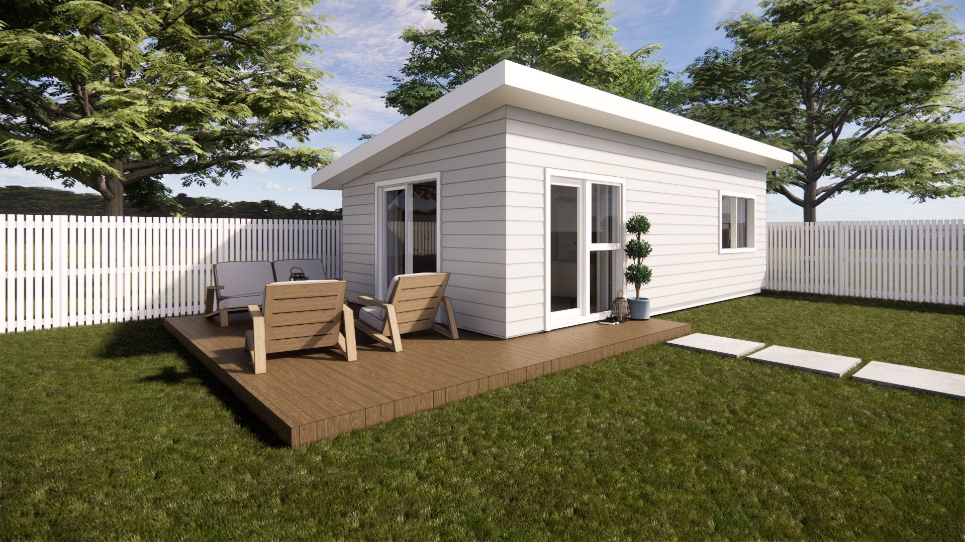A small white house with a deck and chairs in the backyard.