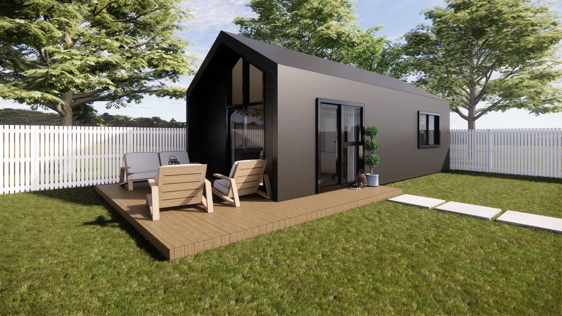 A small black house with a deck and chairs in the backyard.