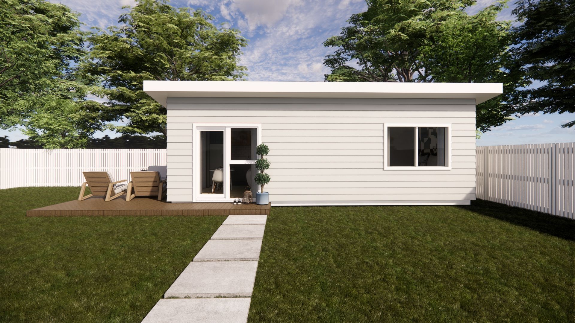 A small white house is sitting in the middle of a lush green yard.