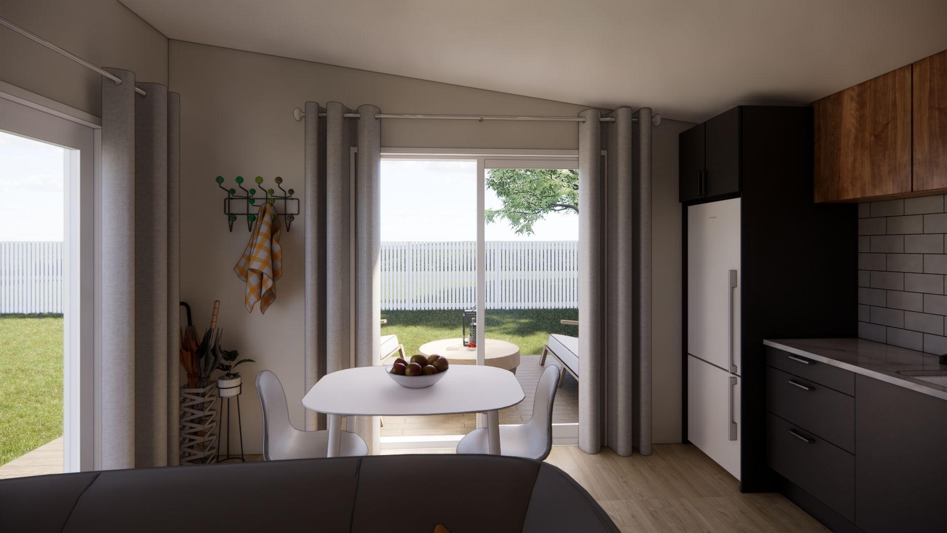 A living room with a table and chairs and a kitchen.