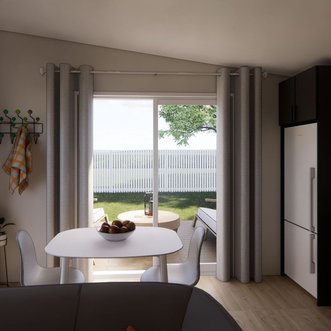 A living room with a table and chairs and a sliding glass door.