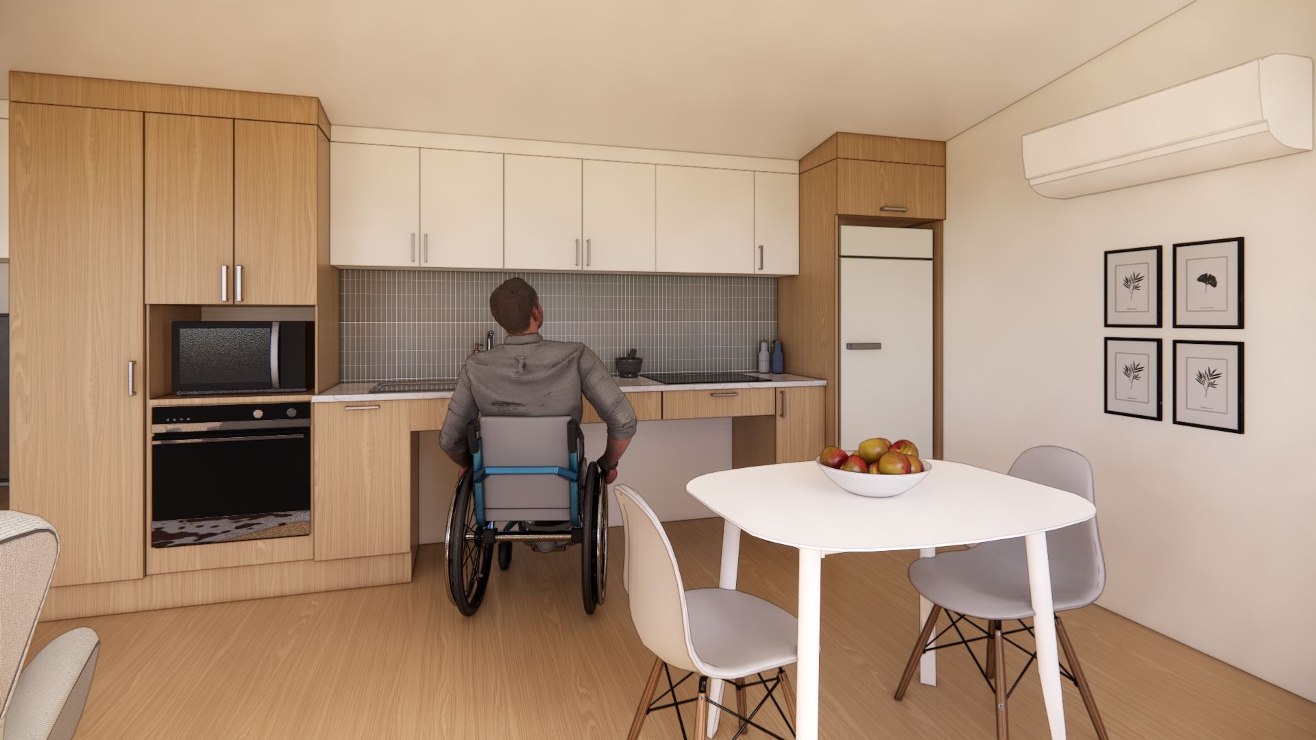 A man in a wheelchair is sitting at a table in a kitchen.