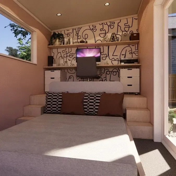 A bedroom with a bed and a computer on the wall