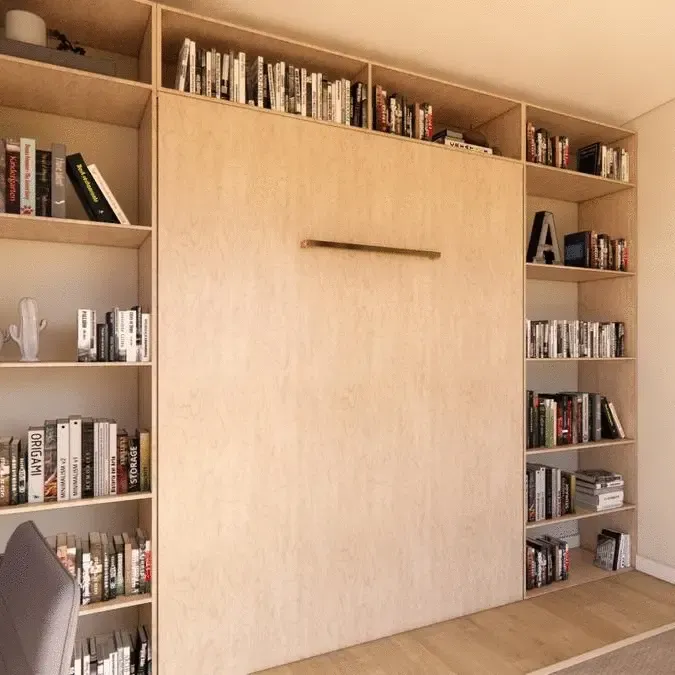 A wall filled with books and a shelf that says ' a ' on it