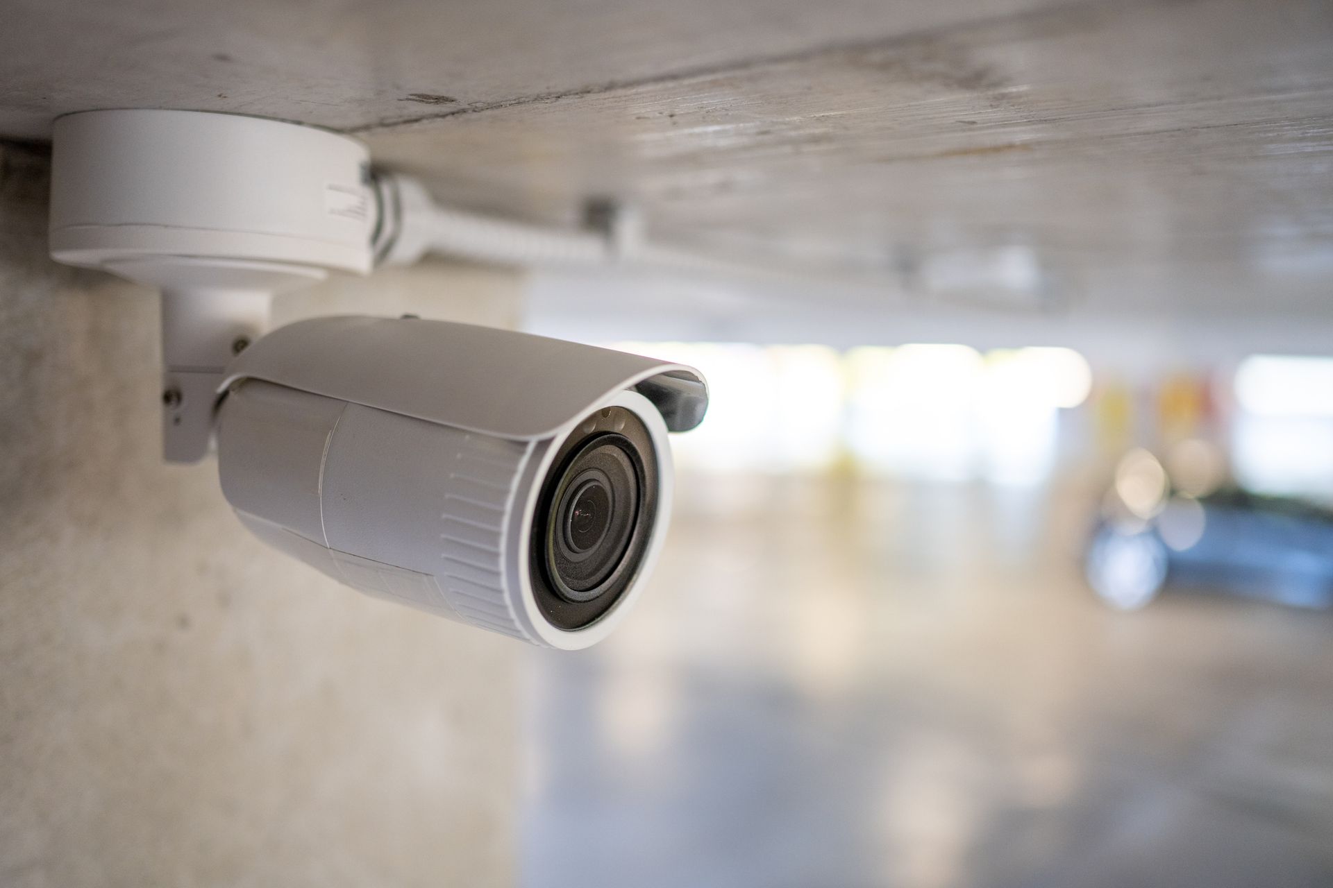 Close-up of surveillance camera in underground parking space | Cairns