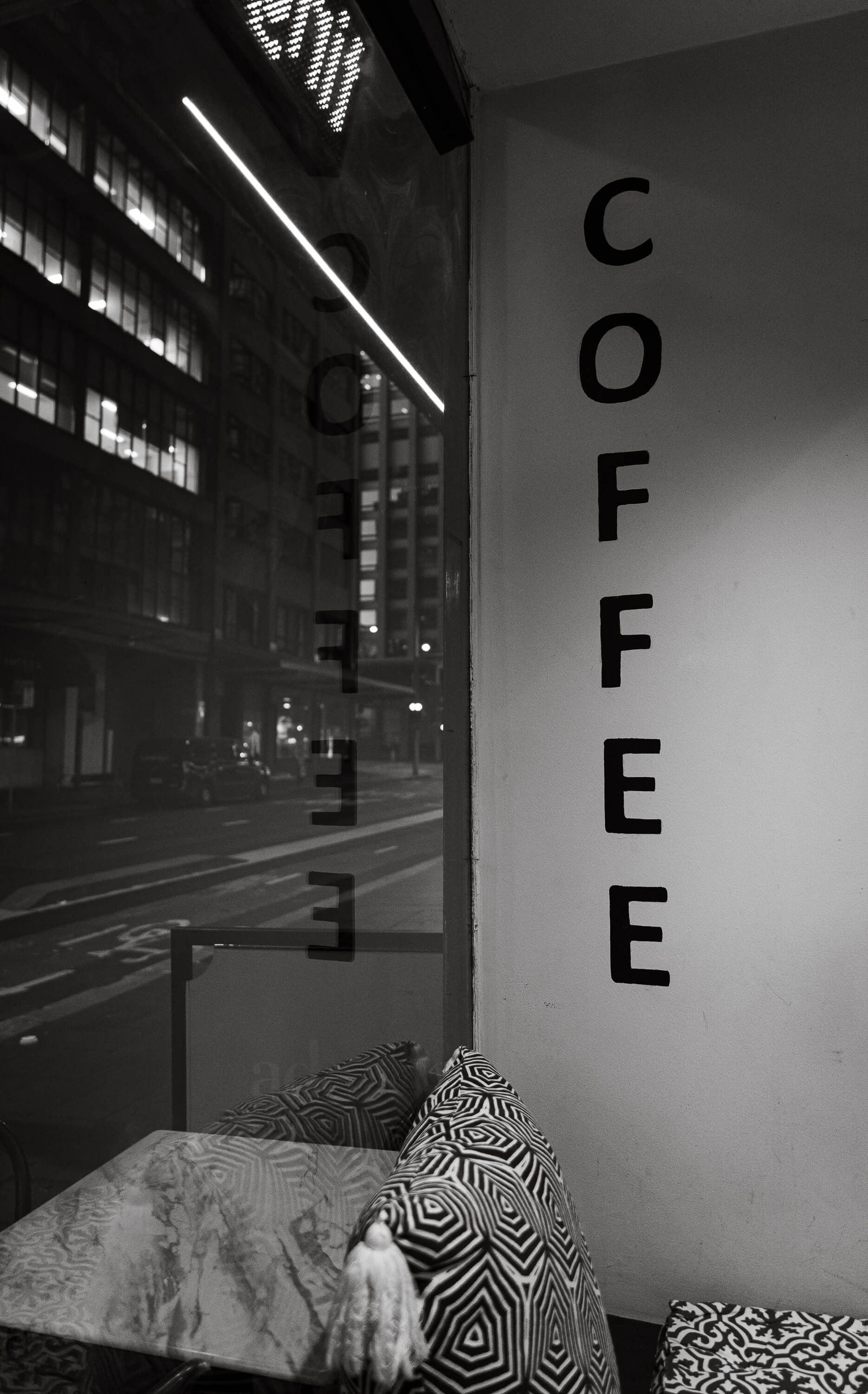 Black and white photo inside a coffee shop. 