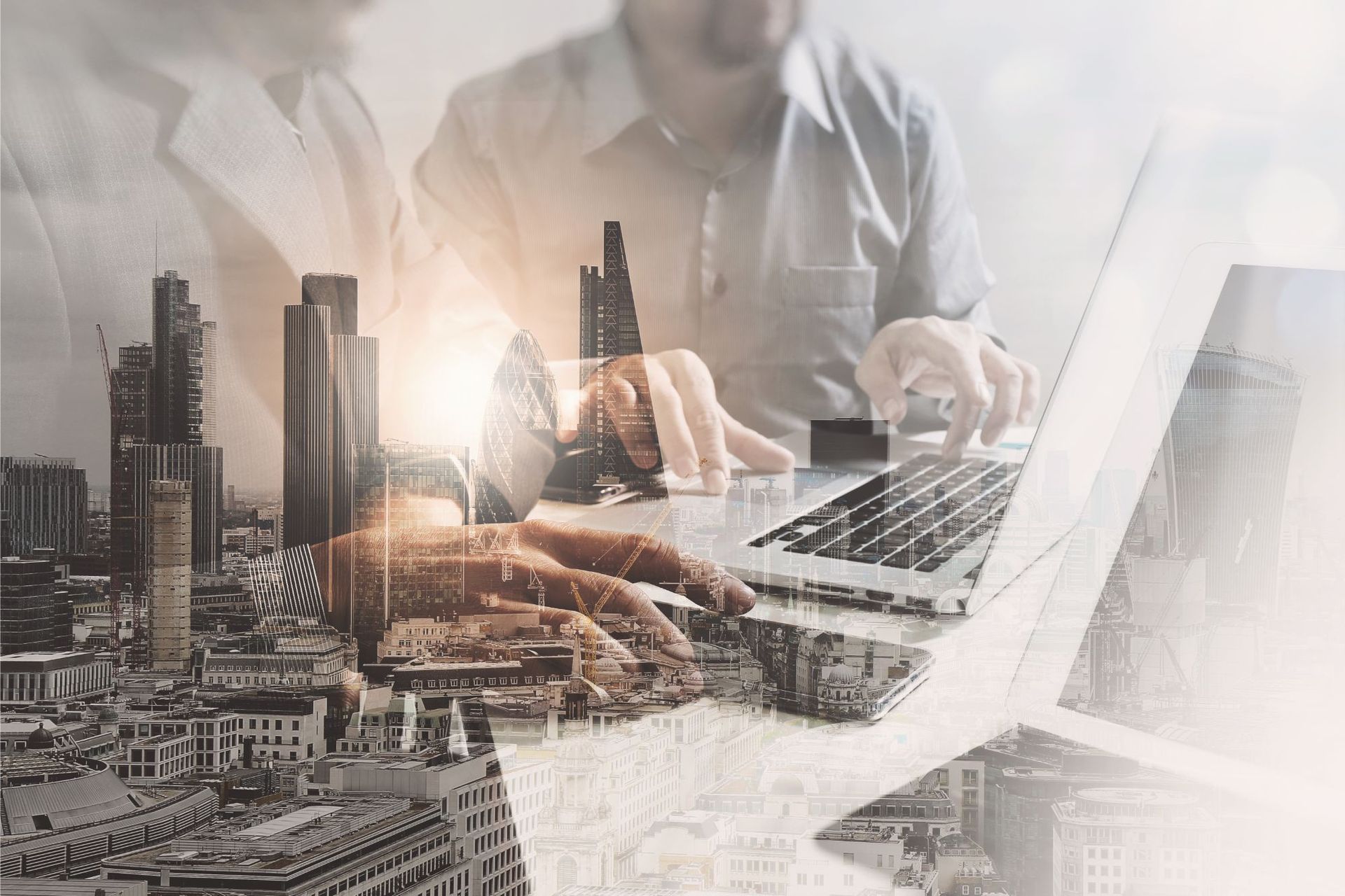 Two people working on a laptop, overlaid with a cityscape.