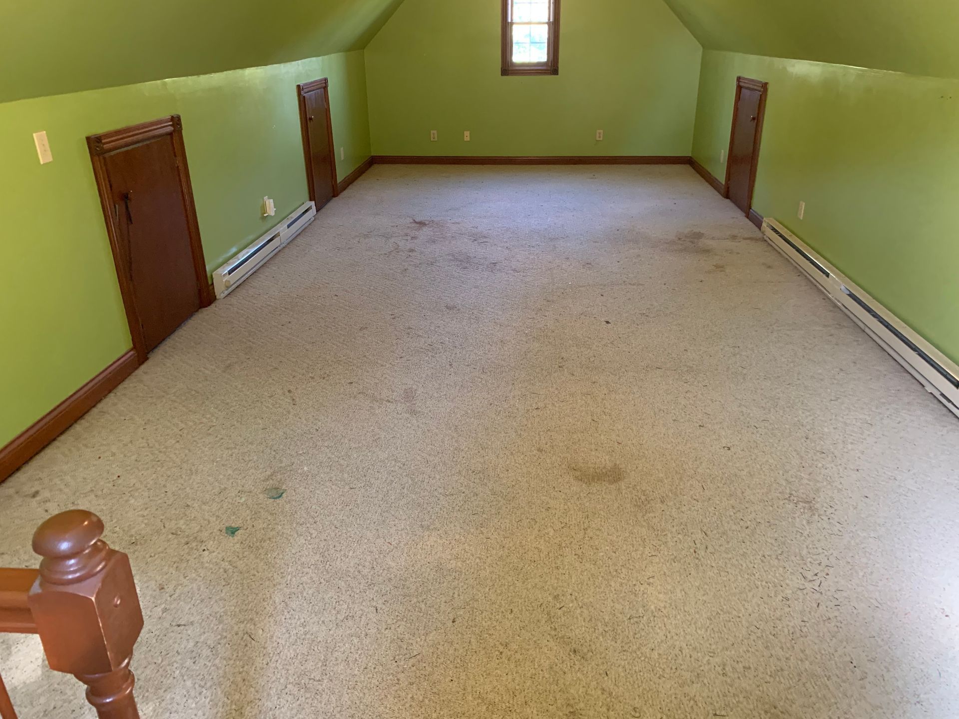 Scattered moving boxes and household items on a wooden floor, with a mop in the foreground.