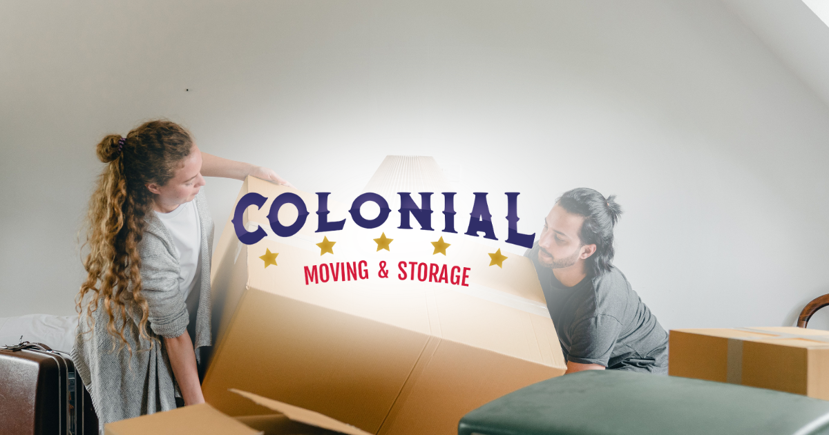 Two people moving boxes with Colonial Moving & Storage logo between them