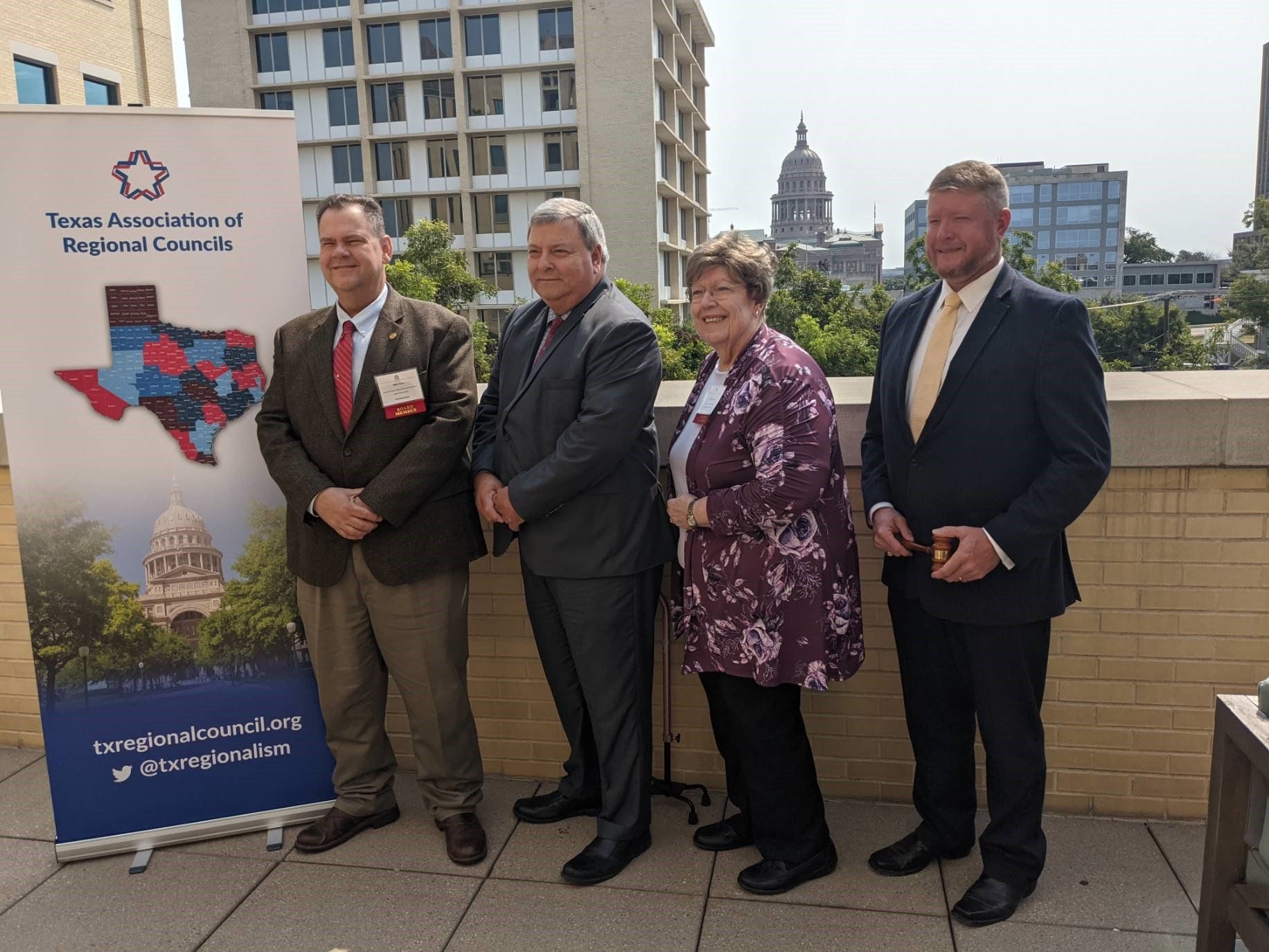 A group of people standing in front of a sign that says texas