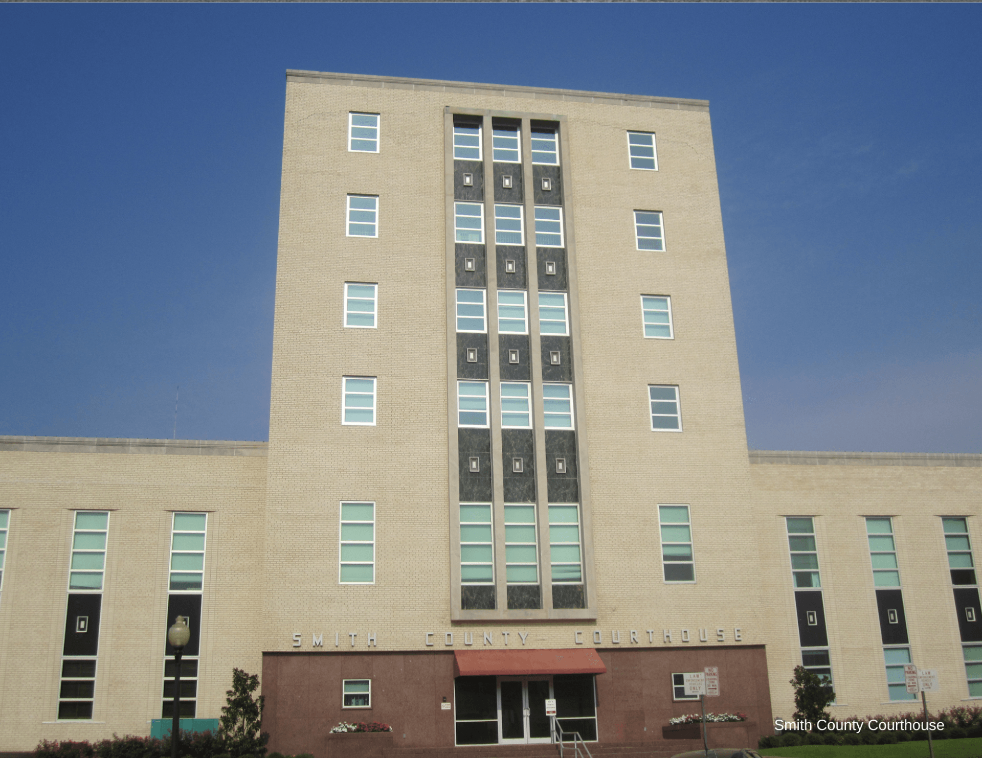 A large brick building with a blue sky in the background