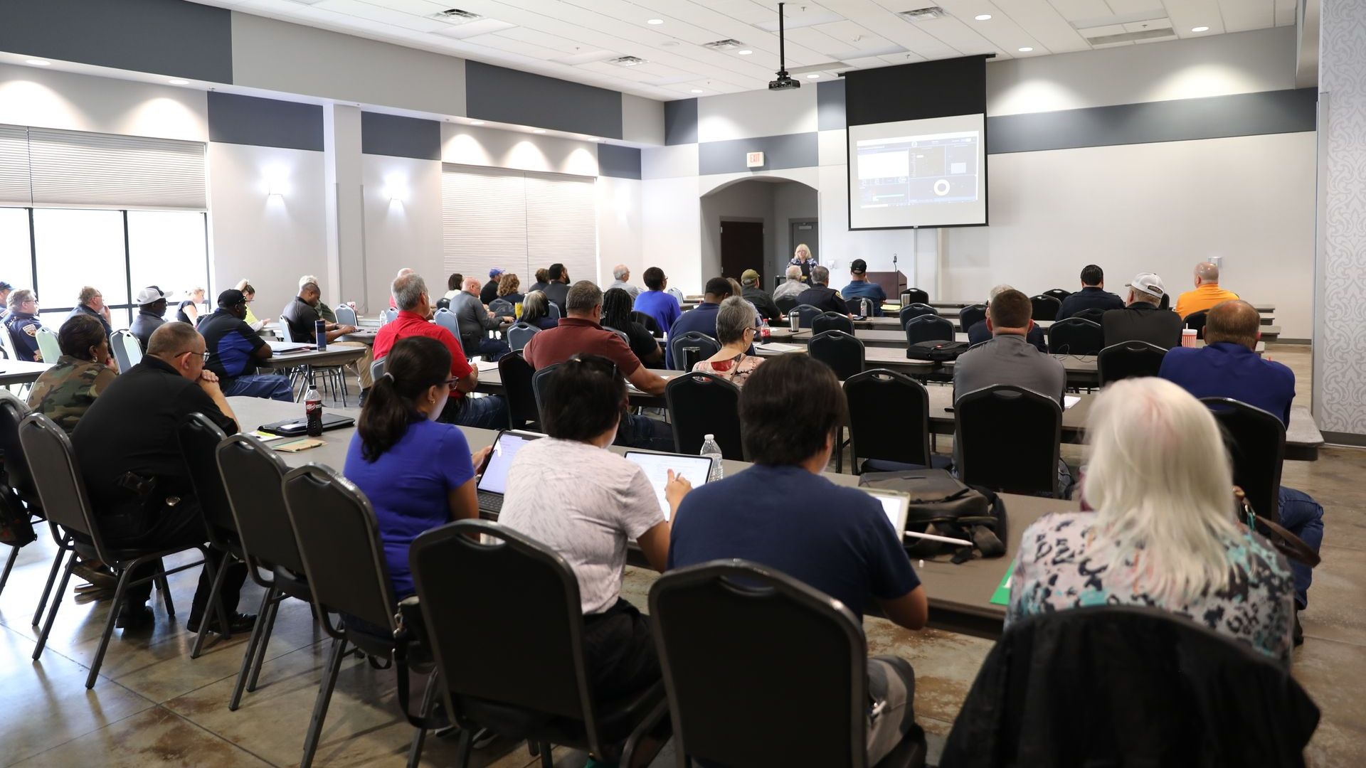 A large group of people are sitting in a conference room.