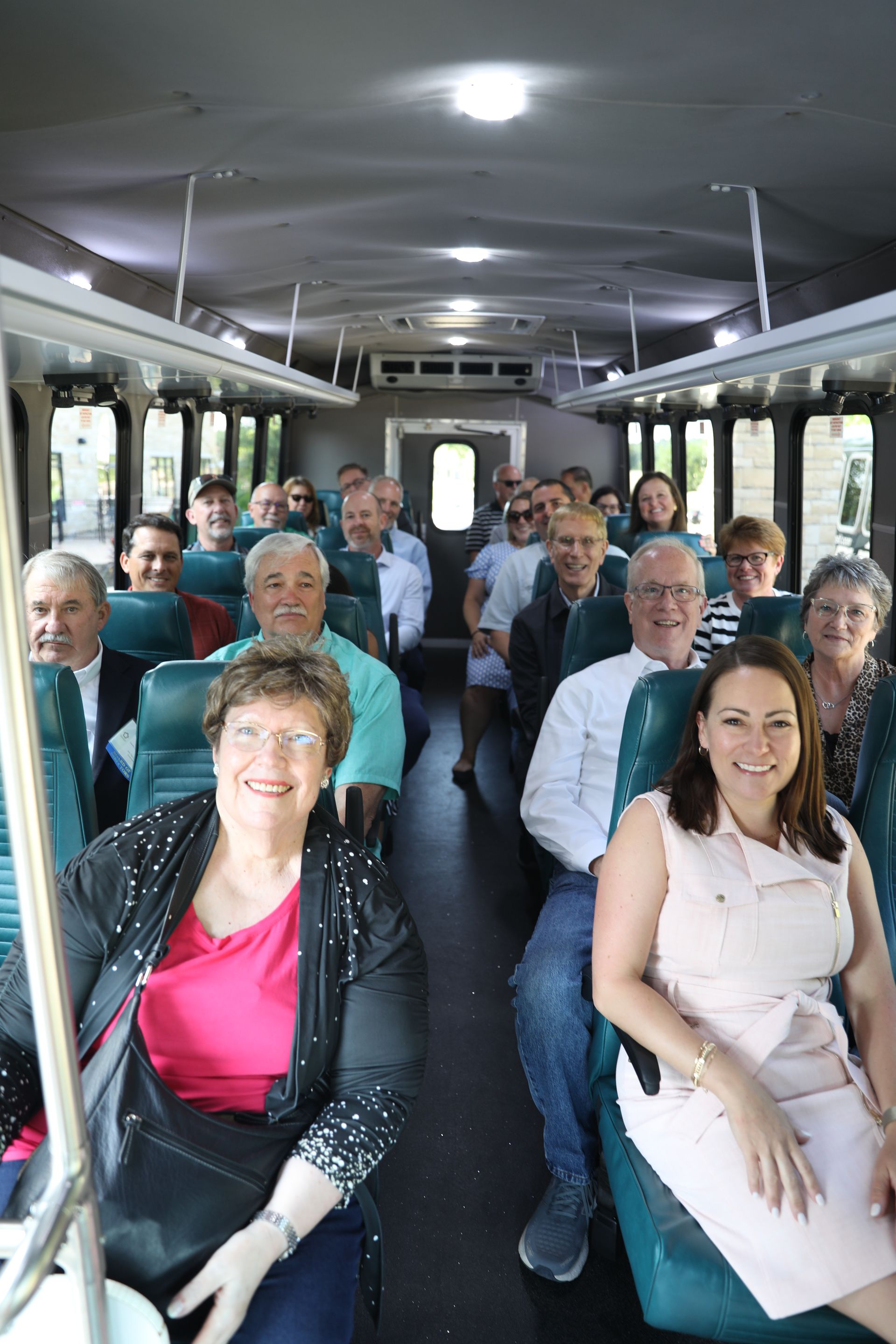 A group of people are sitting on a bus.