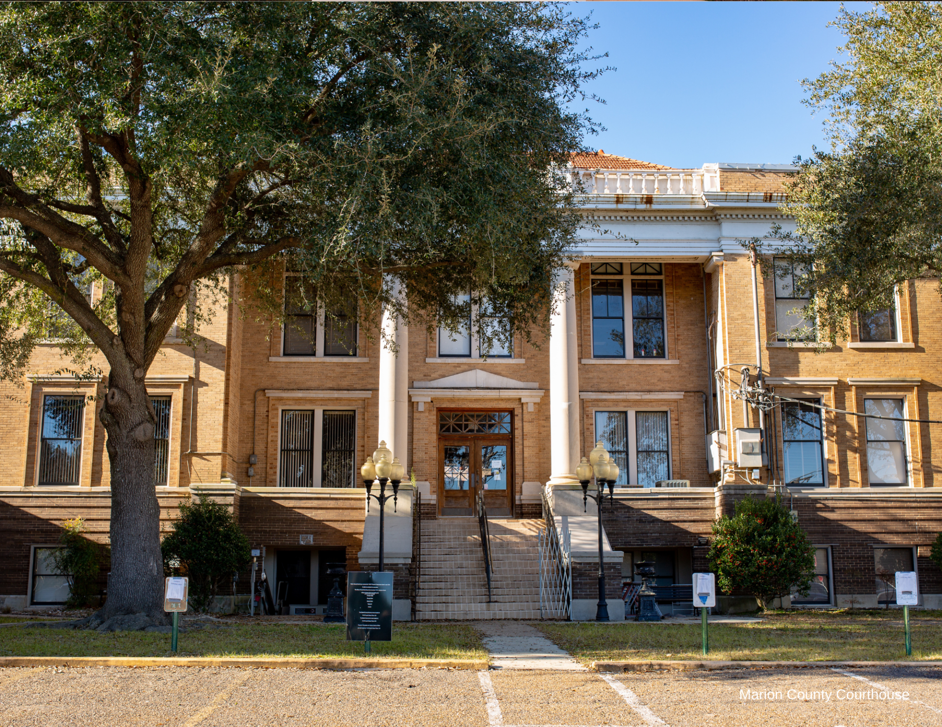 A large brick building with a tree in front of it