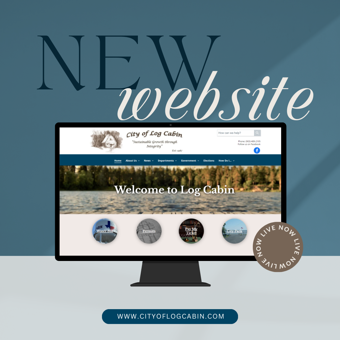 A computer monitor is displaying a new website for log cabin
