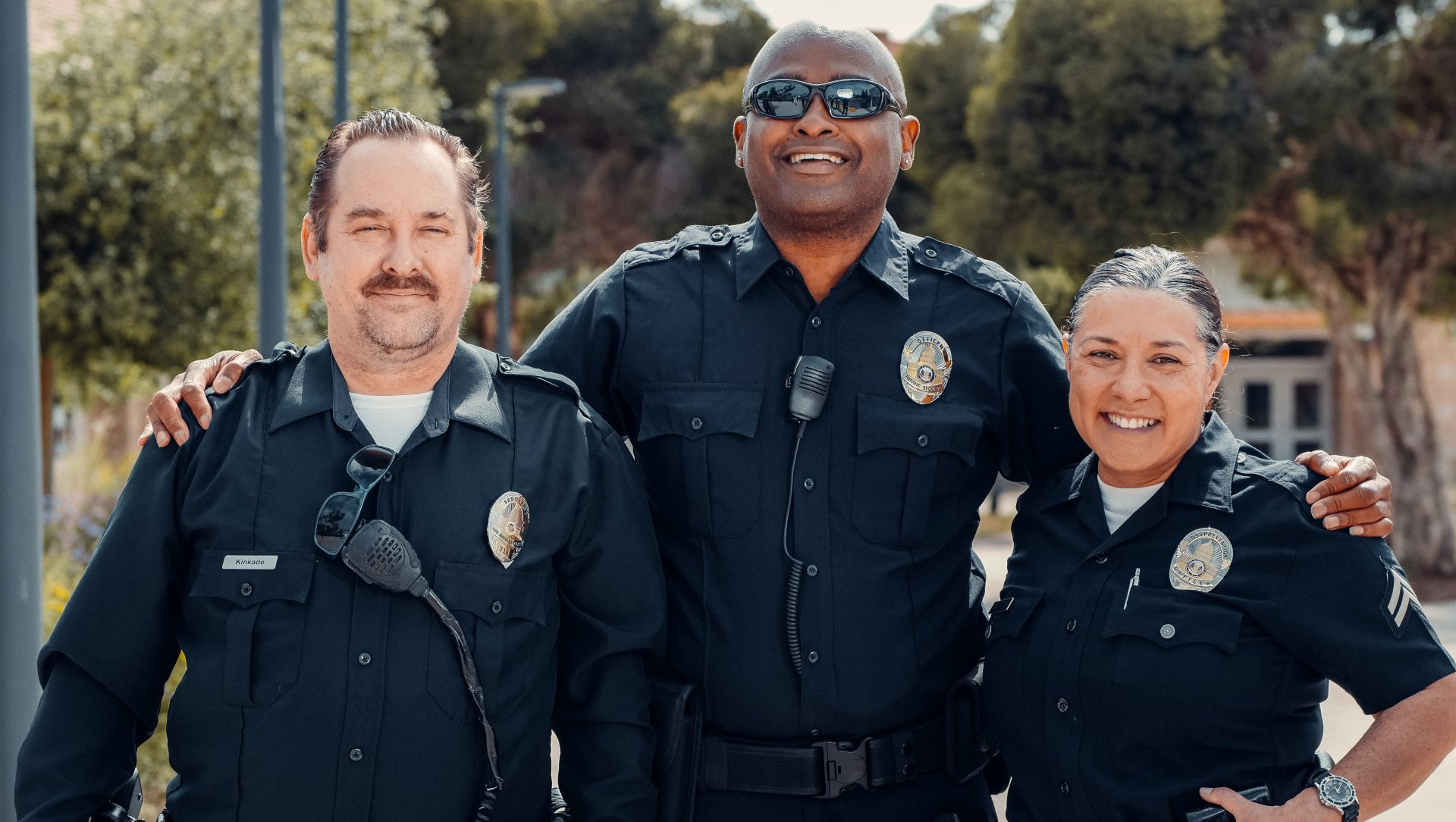 Three police officers are posing for a picture together.