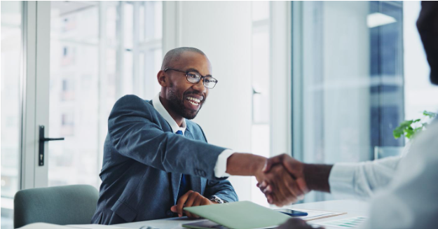 A long-term disability lawyer shakes hands with a client in a Toronto office, offering support to protect a client’s rights.