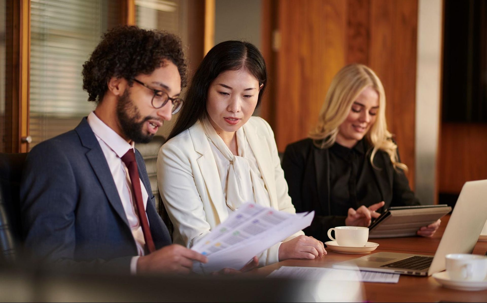 Lawyer and clients going over documents together.