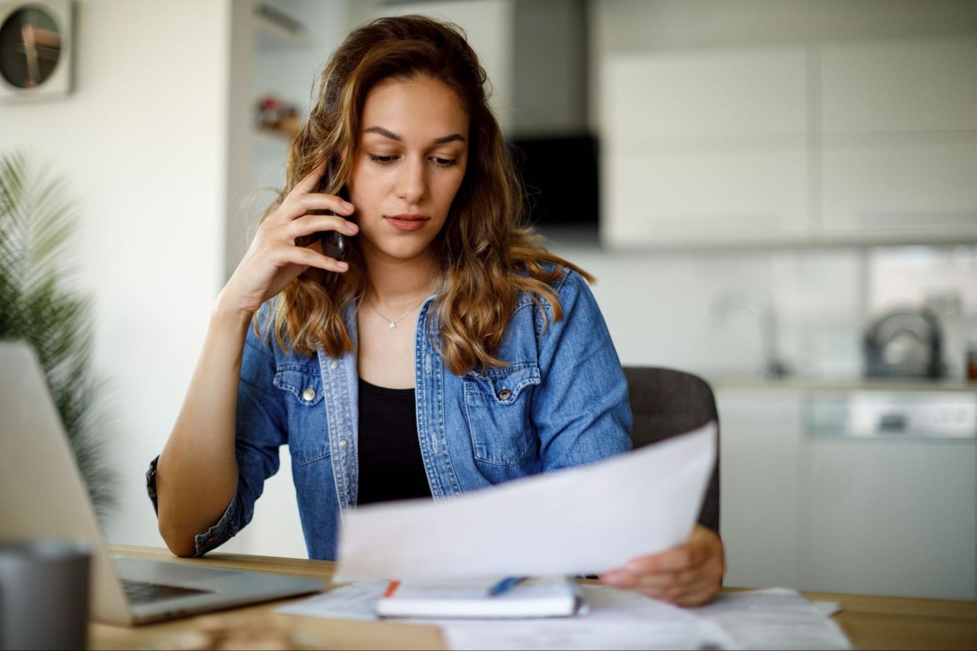 Woman looking at a document on the phone with an Ontario disability lawyer.