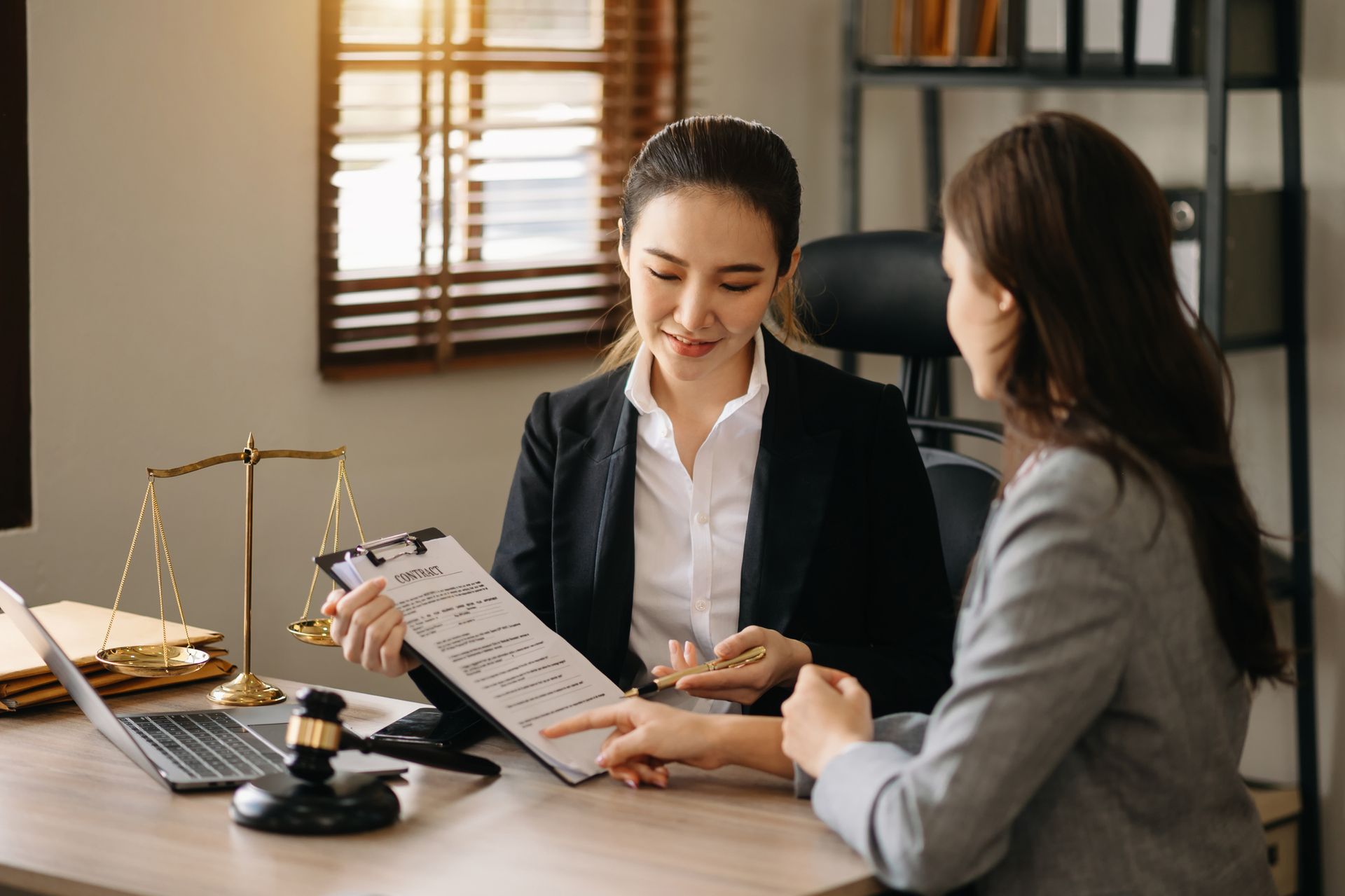 A lawyer sitting with a client, discussing legal documents, symbolizing professional legal assistance for slip-and-fall cases.