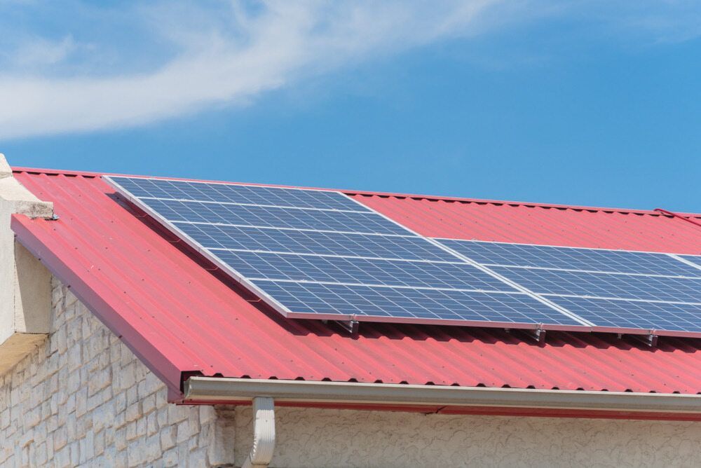 A Red Roof With Solar Panels on It — Eco Sparks Solar & Electrical Contractors in Darwin, NT