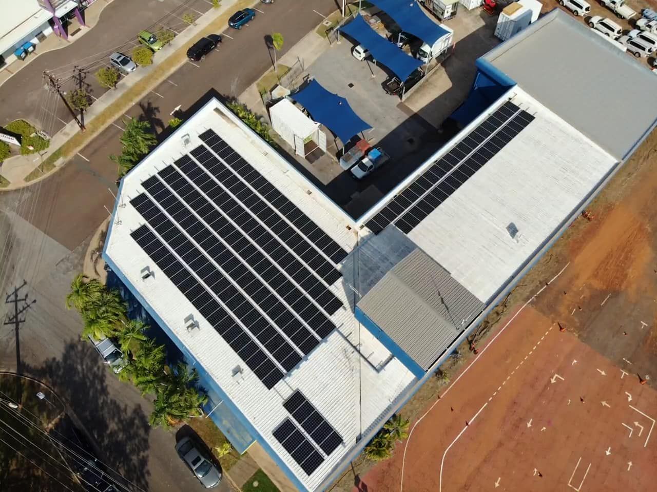 An Aerial View of a Building With Solar Panels on the Roof — Eco Sparks Solar & Electrical Contractors in Humpty Doo, NT