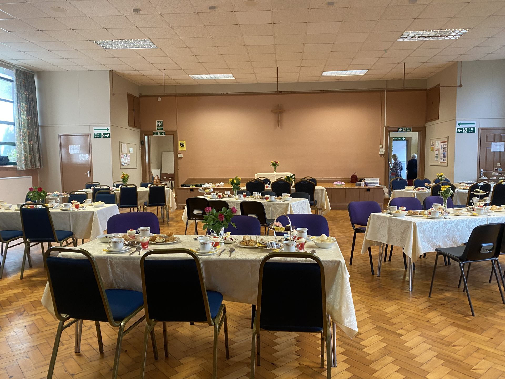 A large room with tables and chairs set up for a party