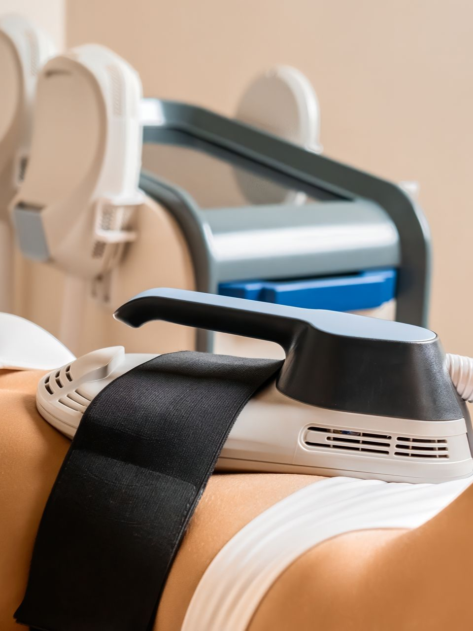 Close-up of a laser hair removal device on a person’s leg in a clinic setting