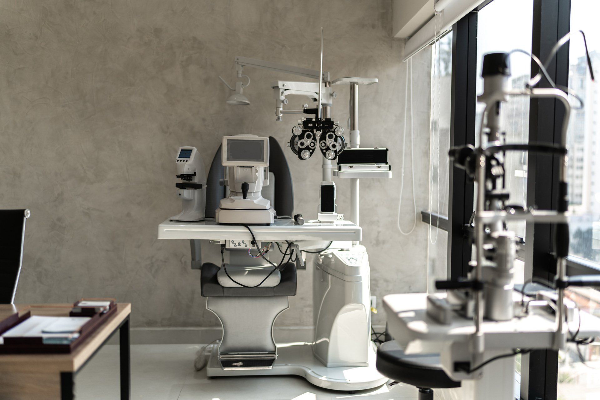 An ophthalmologist 's office with a lot of equipment on the table