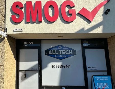 SMOG test shop storefront with red sign, ALL TECH logo, and blue smog check notice on door