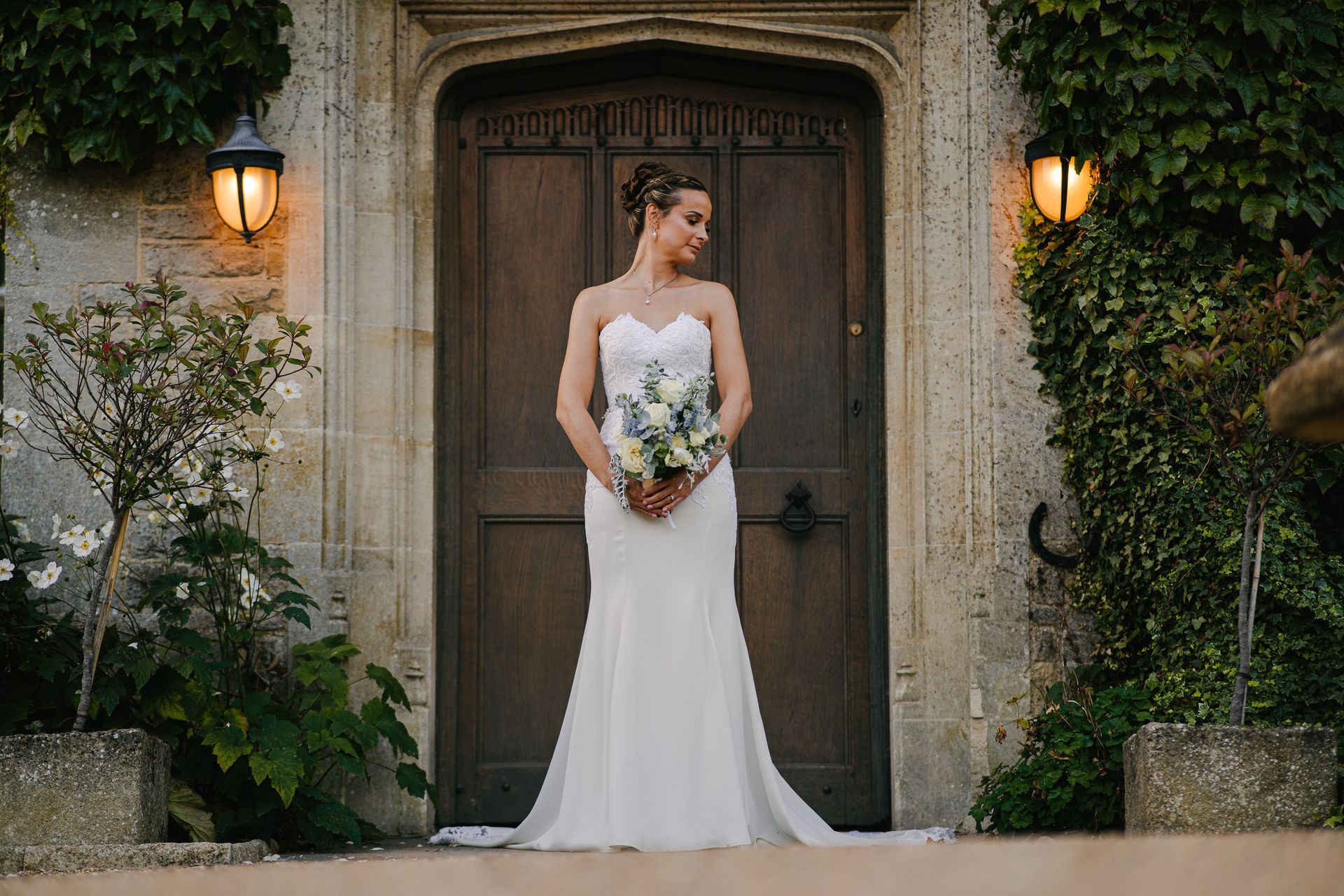 bride portraits infant of wooden door at minor house , Hyde house cotswolds 