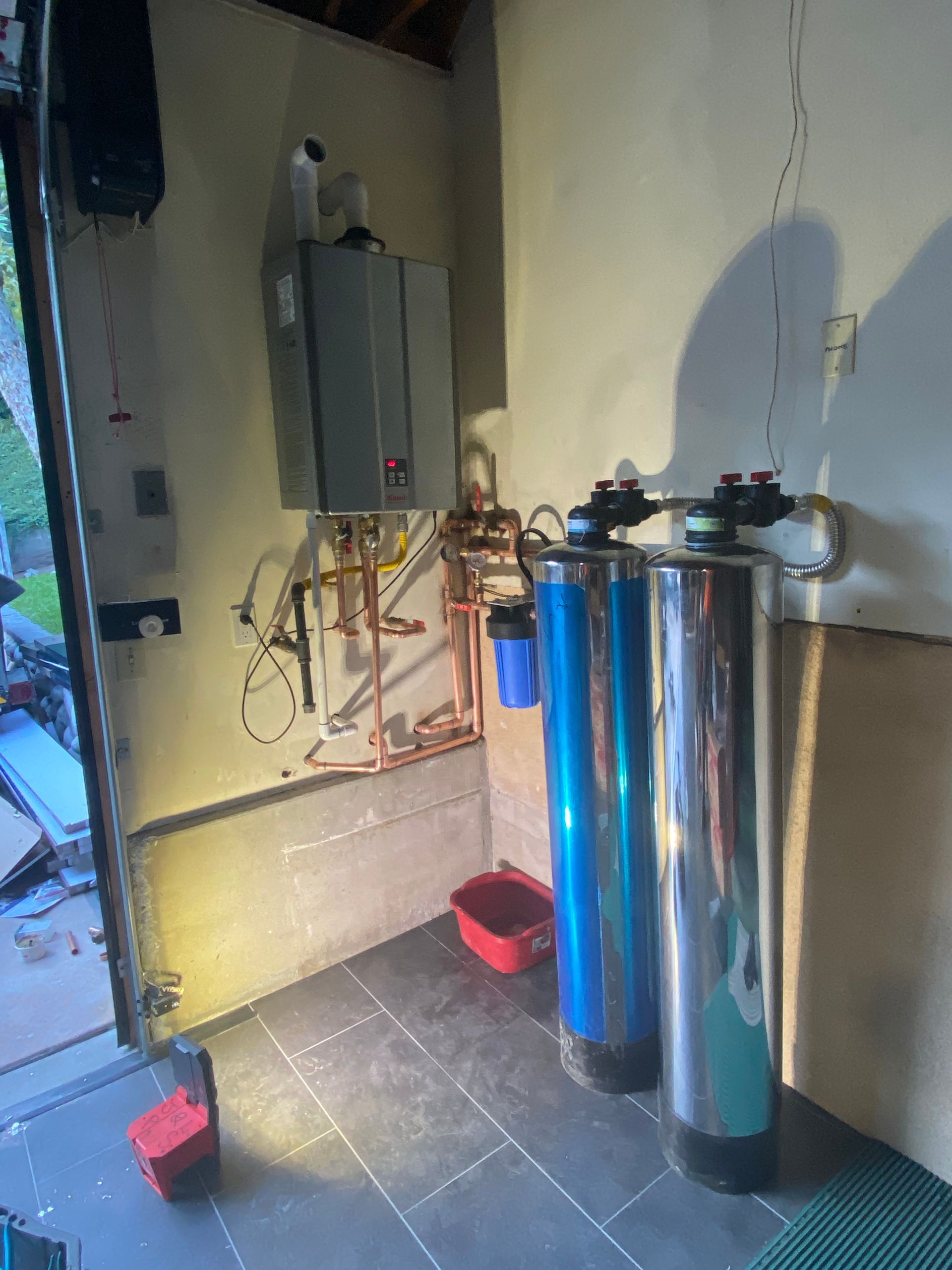 A Room with Two Water Filters and A Water Heater.