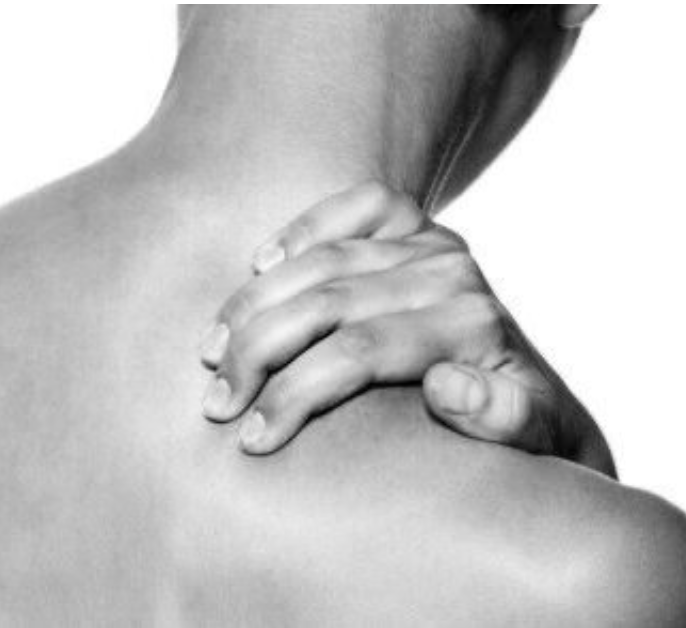 A person with their hand gripping their shoulder in a gesture indicating pain or muscle discomfort.
