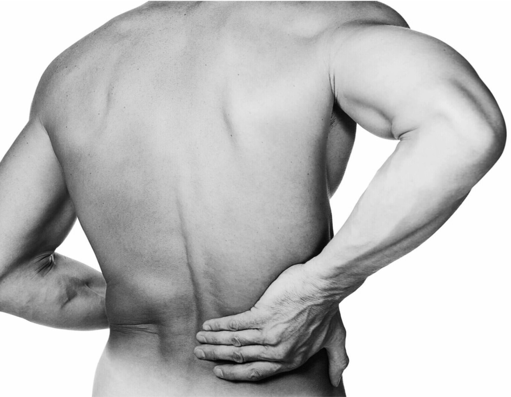A person seen from behind holding their lower back with one hand, indicating pain or discomfort.